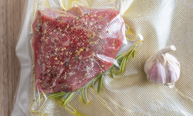 A seasoned piece of meat in a plastic bag